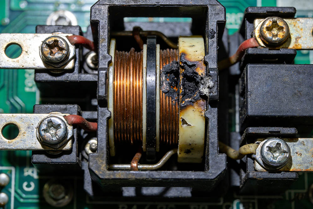 Damaged electrical contactor components close-up